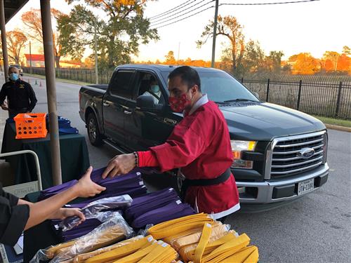 Mr. Moreno reaches out for a purple belt. 