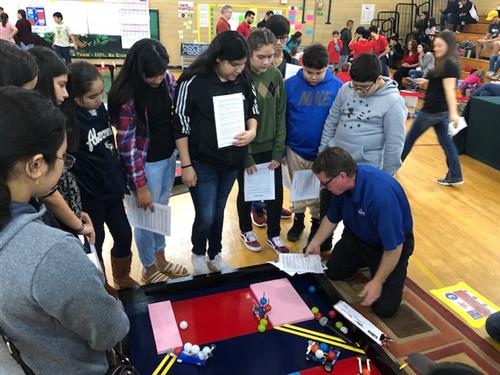 Mr. Junkin and students examining the rules. 