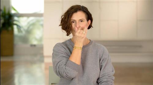woman holding nose
