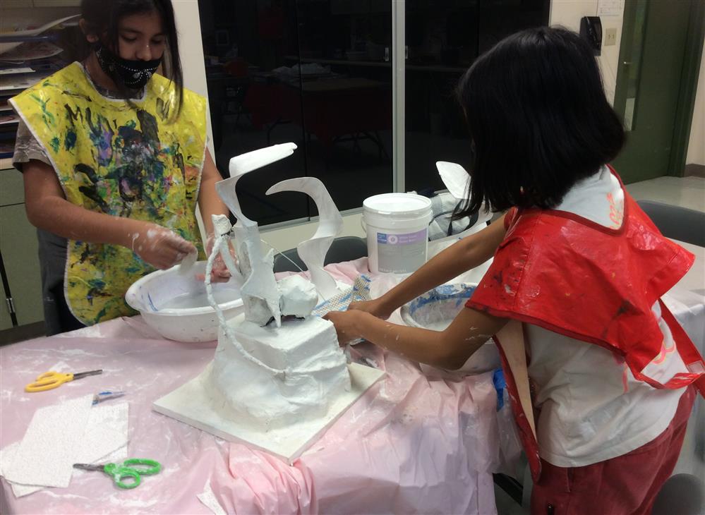 Students sculpting with plaster 