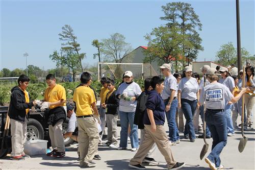 Group of teachers, students and volunteers working.